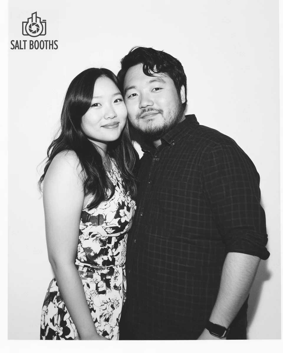 Studio-lit black-and-white Glam booth portrait of a couple
