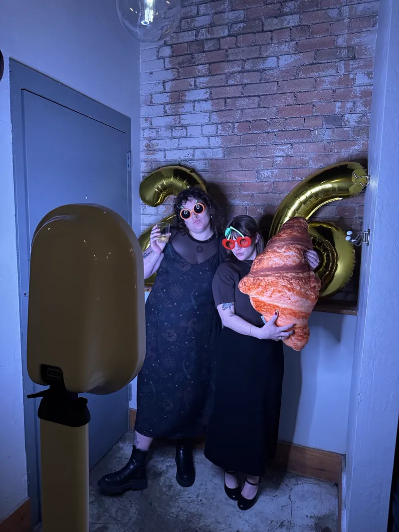 Guests with giant croissant balloon