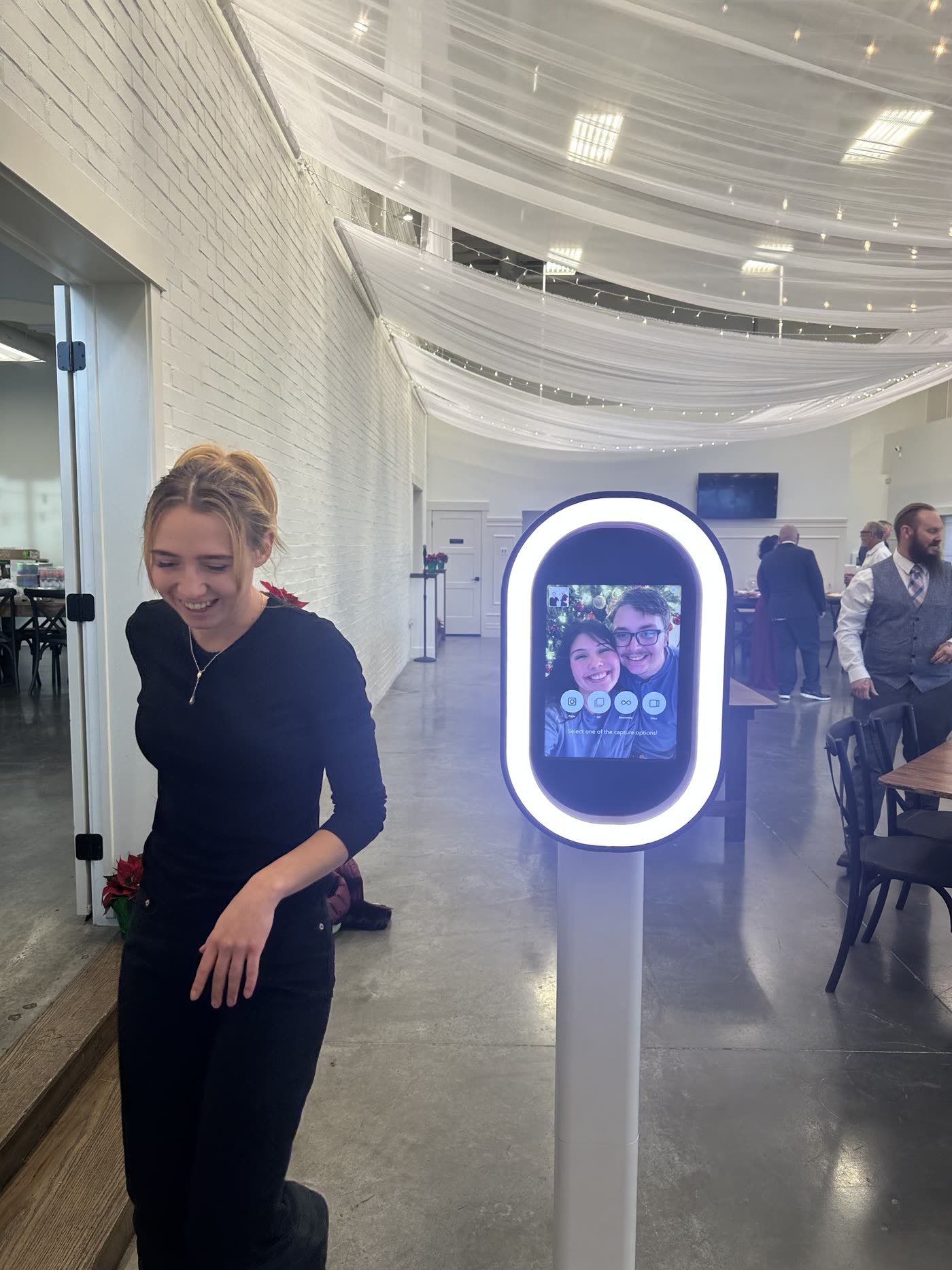 Self-serve DIY iPad photo booth on a stand at a wedding reception